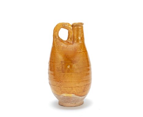 AN AMBER GLAZED FLASKLiao DynastyTypically modelled after a leather pouch-form flask, with an upright loop handle and cylindr