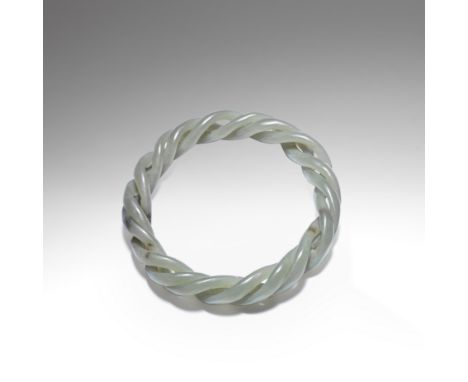 A GREEN AND MUSHROOM JADE ROPE-TWIST BANGLEQing DynastyThe green stone with cloudy-white and mushroom inclusions, skilfully c