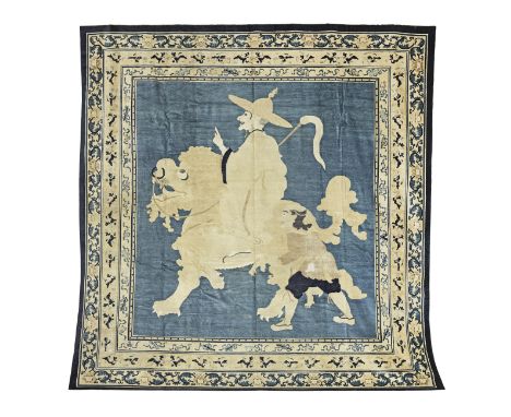 A NINGXIA 'LUOHAN' CARPETNorth China, circa 1880Woven in tones of blue and cream wool with a central panel depicting a luohan