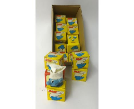 A collection of small Smurf novelty egg cups and cosies, boxed (14).
