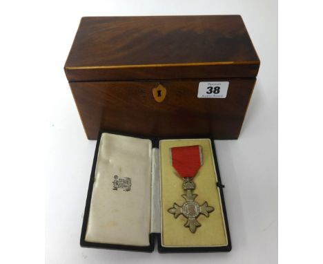 An MBE medal, cased, together with a 19th Century mahogany tea caddy.