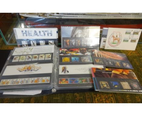 An album of First Day Covers also loose commemorative issue stamp sets.