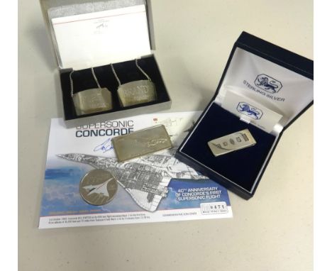 Concorde, a sterling silver clip, a silver commemorative ingot, a pair of Concorde silver decanter labels and Anniversary Fli