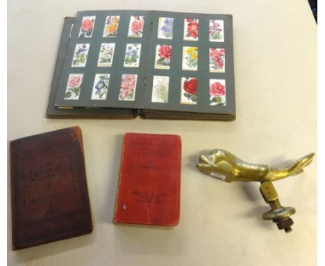 Various items including heavy dolphin brass door knocker, part album of cigarette cards, Masonic regalia, sundry books includ