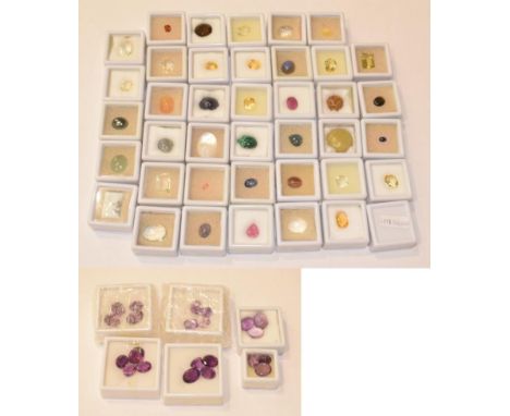 A quantity of loose gemstones including amethysts, smoky quartz, rock crystal, haematite, malachite, hessonite garnet, lead g