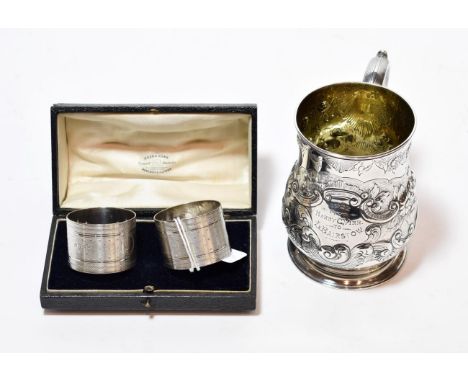 A Victorian silver christening-mug, by Robert Hennell, London, 1875, baluster and on spreading foot, chased with foliage scro