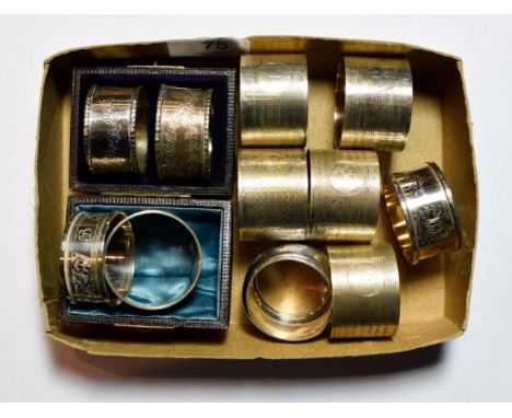 Eleven various silver napkin-rings, including: a pair in fitted case; a set of five engine turned examples, numbered 2-6; a p