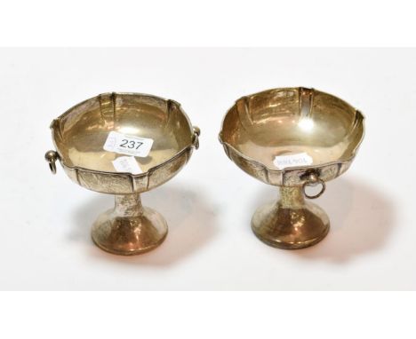 A pair of George V silver pedestal dishes, by William Hutton and Sons, Birmingham, 1913 and 1914, each shaped circular and wi