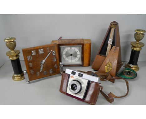 Three Art Deco time pieces, a French Maelzel metronome, a Kodak camera and a pair of brass candlesticks