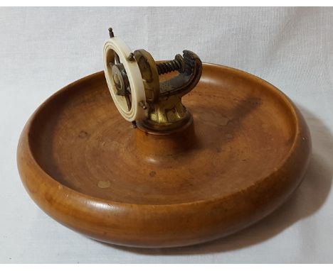 Novelty nut cracker in the form of a ships wheel mounted in turned wooden bowl