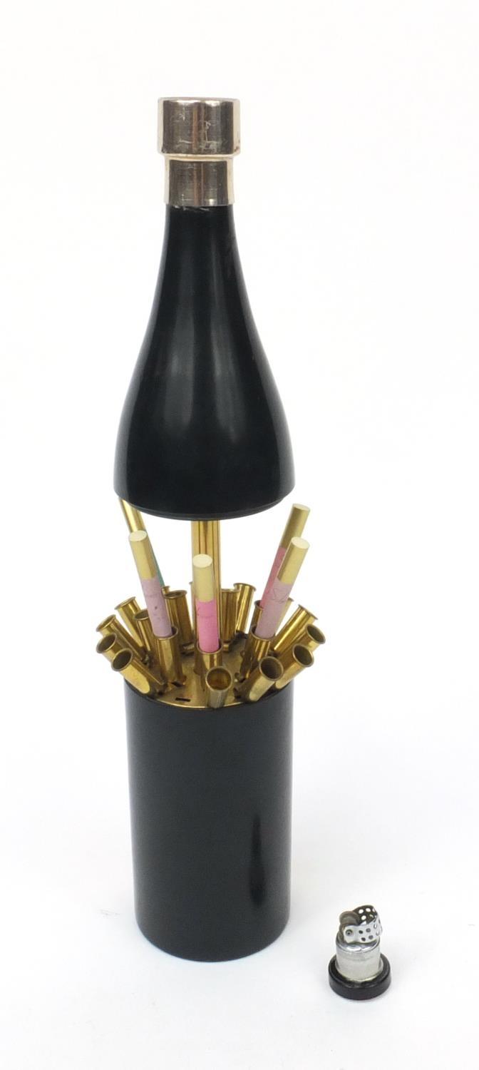 Musical cigarette dispenser and lighter in the form of a bottle of