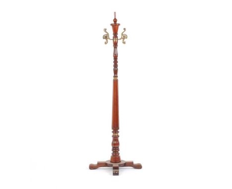 REPRODUCTION MAHOGANY & BRASS REVOLVING HAT & COAT STAND ON TURNED PILLAR ON 4 SPLAYED FEET. HEIGHT: 68 INCHES.GOOD CONDITION