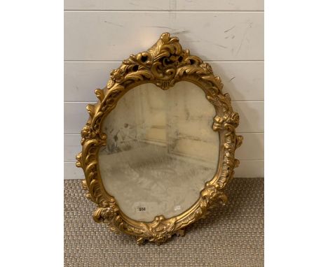 A Rocco style mirror with gilt plaster frame (43cm x 60cm)