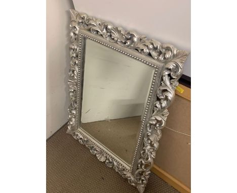 A carved wall mirror (77cm x 97cm)