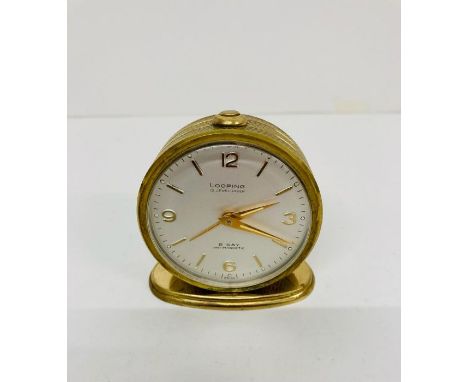 A Vintage Looping 15 jewel lever 8 day antimagnetic travel clock
