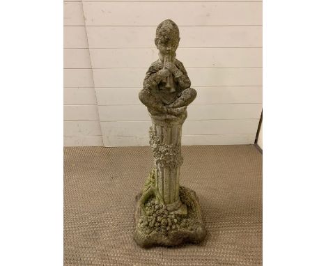 Garden stone figure of a boy playing flutes, seated. H 90 cm