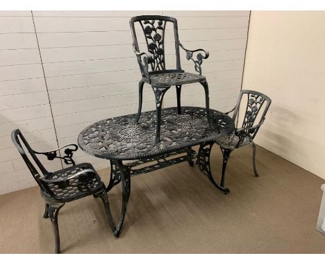 An oval metal garden table with three matching chairs (W 140 cm x D 84 cm x H 75cm)