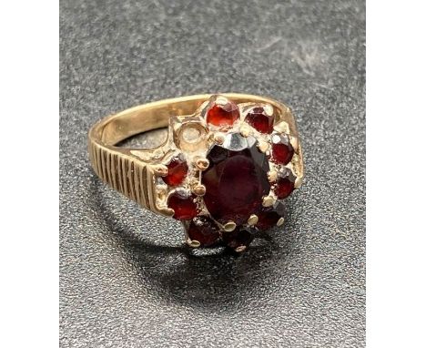 A 9ct yellow gold and garnet ring. (Total Weight 5g)