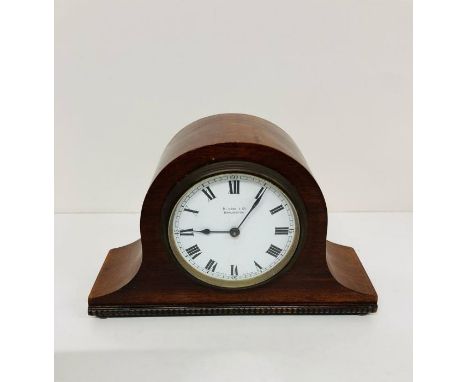 A small mahogany Napoleon mantle clock