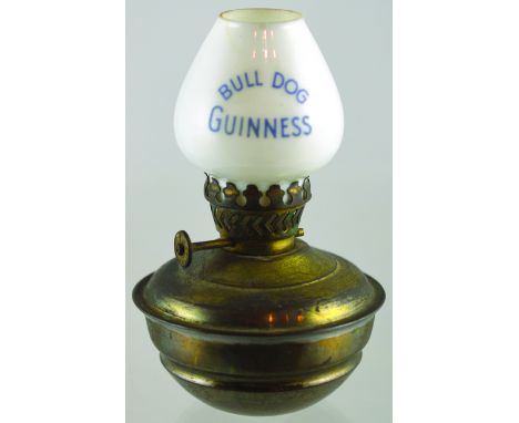 GUINNESS LAMP. 5ins tall, brass base, white glass chimney with BULL DOG/ GUINNESS in blue lettering. Not seen another. Good (