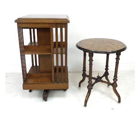 An Art Deco oak revolving bookcase on an X frame base with castors, 48 by 48 by 90cm high, together with a Victorian mahogany