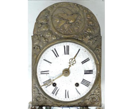 A French 19th century comtoise clock, the white enamel dial with black Roman numerals, in a typical decorative repousse brass