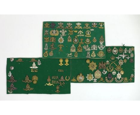 A collection of over ninety WWII British army bades and buttons, including Royal Fusiliers, Tank Regiment badges, and some po