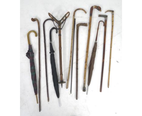 A group of twelve vintage walking sticks and umbrellas, of different styles including two with silver collars. (12) 