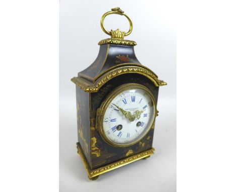 An Edwardian Waring & Gillows retailed chinoiserie mantel clock, with eight day movement chiming on a bell, white dial with R