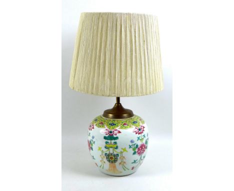 A Chinese Qing Dynasty, 19th century, famille rose ginger jar, later converted to a lamp, the white ground decorated with lot