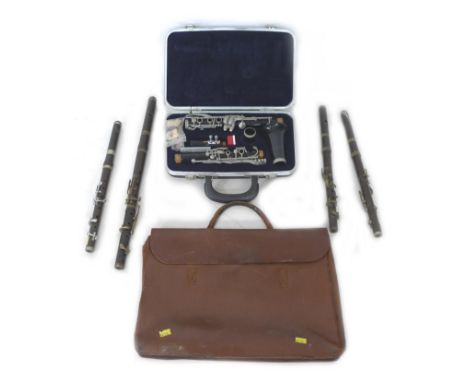 A cased USA made Encore clarinet with accessories and four marching flutes, including one by Rose-Morris with broad arrow mar