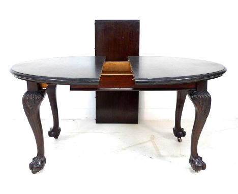 An early to mid 19th century mahogany extending dining table, the oval surface with moulded edge, raised on cabriole legs car