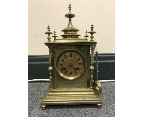 A late 19th century brass carriage clock by R & C of Paris & London with brass finials 