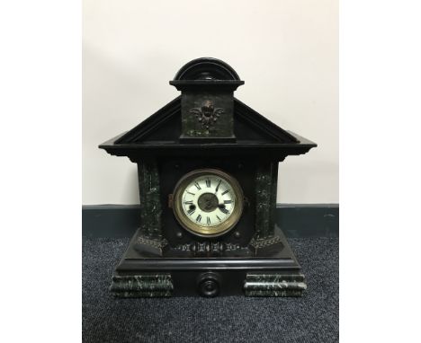 An antique pine cased mantel clock with enamelled dial 