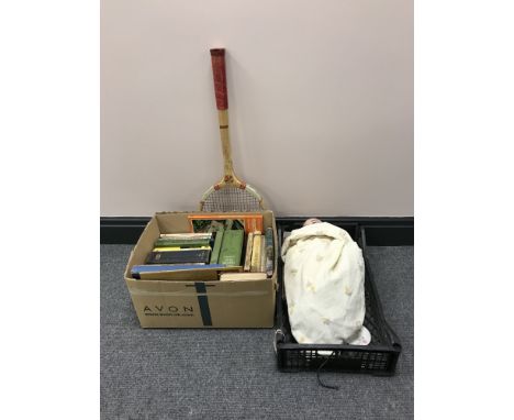 A box containing books, novels, etc . Together with a bisque headed doll, a dolls tea service and a vintage tennis racket 