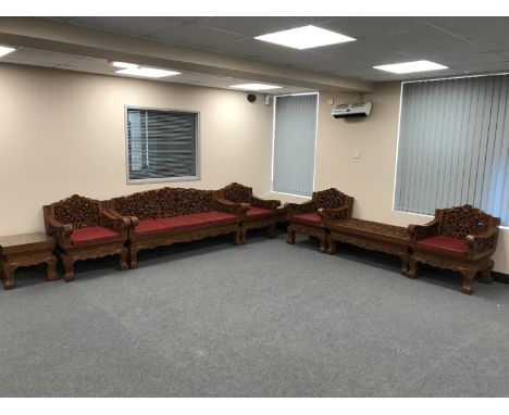 A good quality eight piece carved Eastern hardwood lounge suite, comprising of three seater settee, four single armchairs, co