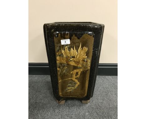 A Chinese earthenware glazed planter with panels depicting bamboo and birds, height 44 cm.