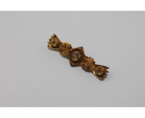 A 15ct gold diamond and ruby brooch, 3.8g