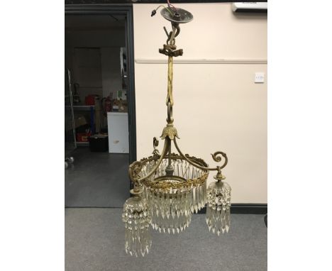 A late 19th century gilt metal and glass chandelier with glass drops  CONDITION REPORT: All of the drops appear to be present