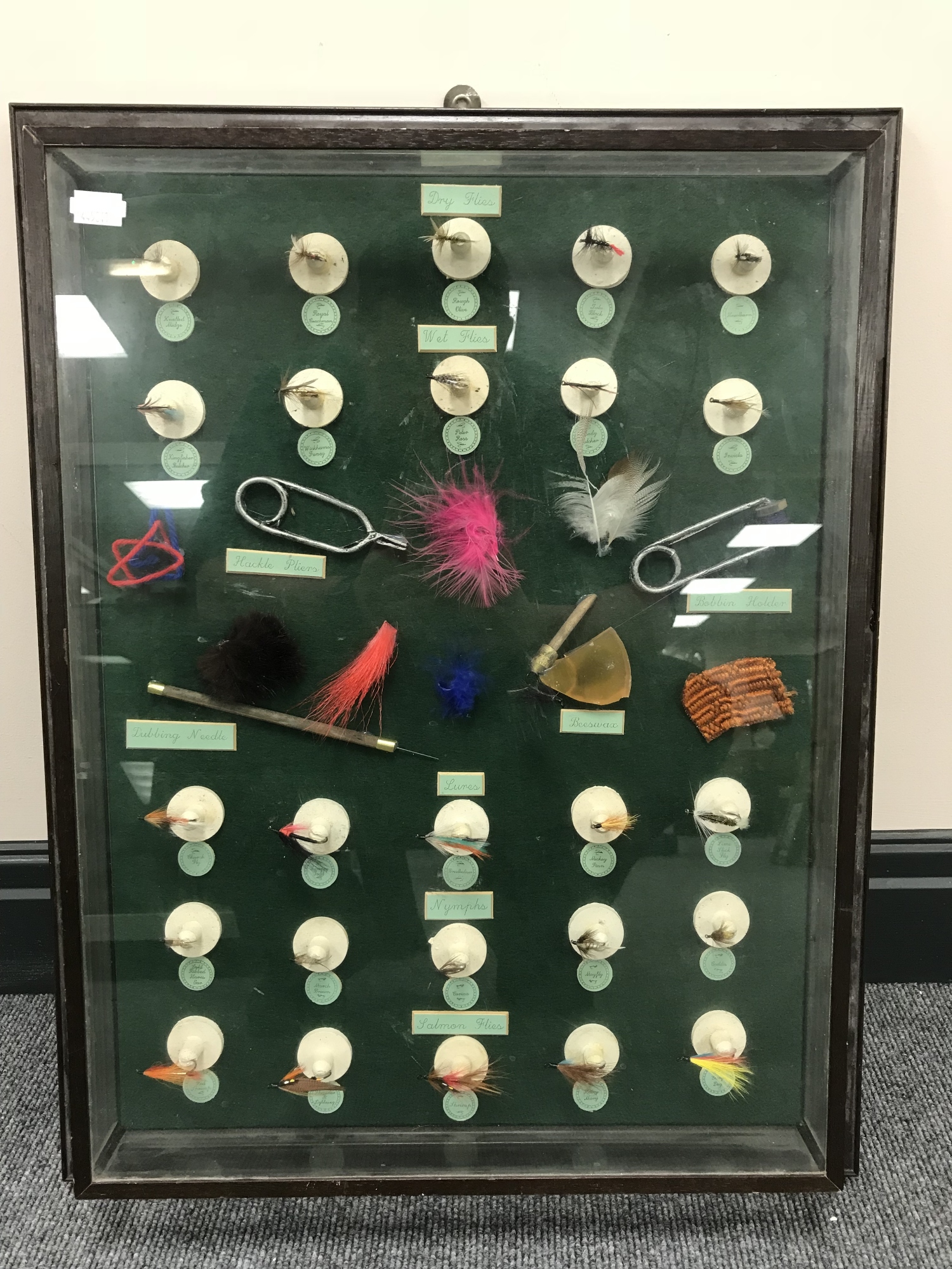A display case containing fishing flies