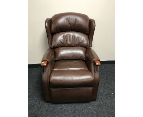 A brown leather manual adjusting armchair