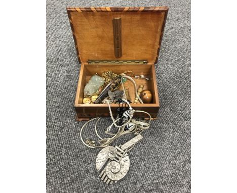 A wooden jewellery box containing assorted costume jewellery, including brooches, necklaces, together with a Chinese jade pen