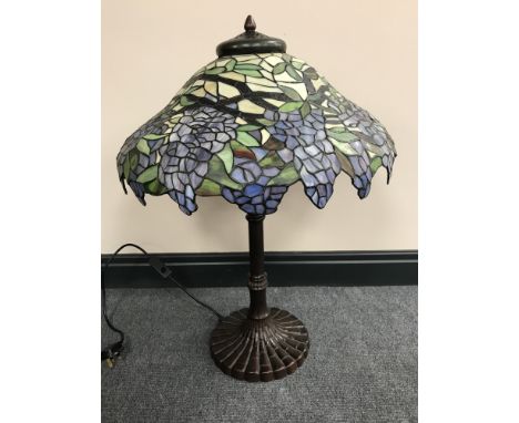 A Tiffany style table lamp with shade  CONDITION REPORT: This lamp has two bulb holders. It is in working order and the shade