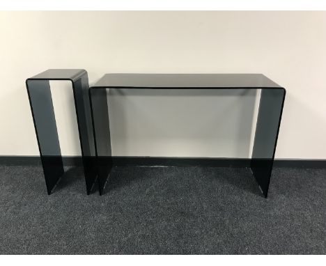 A contemporary black glass console table together with matching plant stand  