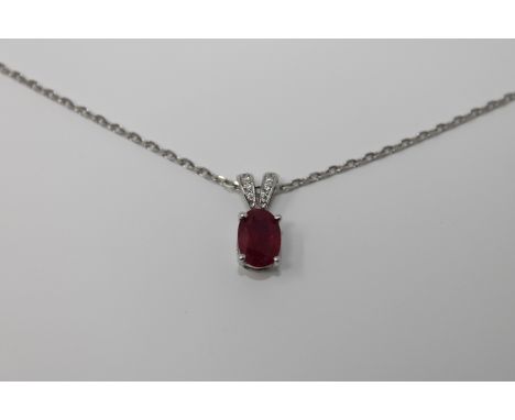 An 18ct white gold ruby and diamond pendant, upon an 18ct white gold chain
