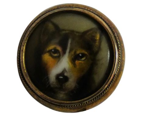 A Victorian gold mounted enamel stickpin depicting a dog, signed W. Essex, 1868, diameter 16 mm and a gilt metal and glass ex