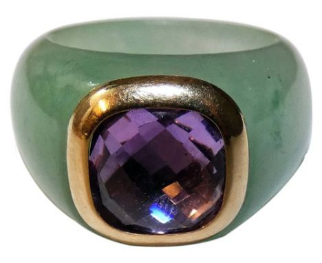 A jade and amethyst set dress ring, untested, the multi faceted gold set stone in a plain mount, size P.