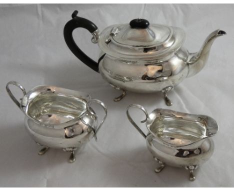 A silver three piece tea service, Birmingham 1992, of oval baluster form raised on pad feet, ebony handle and finial, compris