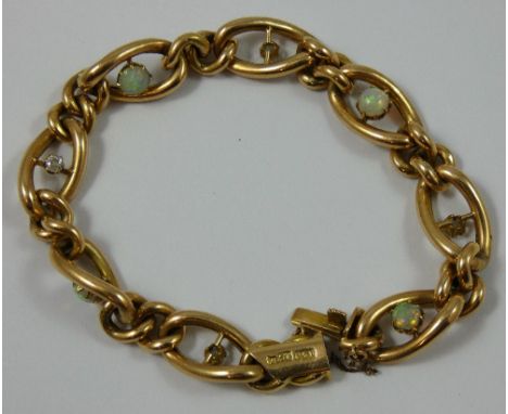 A Victorian 15ct rose gold, opal and diamond hollow curb link bracelet, by A &amp; W, alternately set with collet set opals a