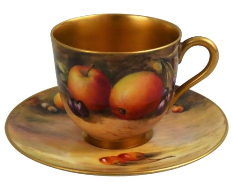 A Worcester hand painted coffee cup and saucer, decorated by H. Sinton, puce mark for 1924, with apples, pears and cherries.